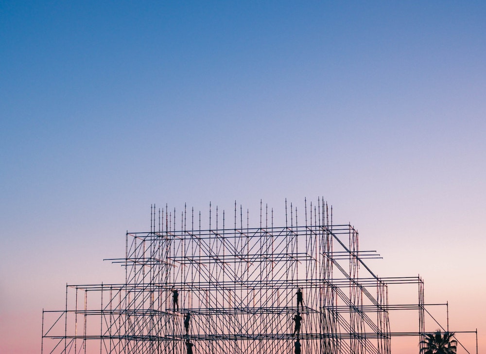 A tower of scaffolding at sunset